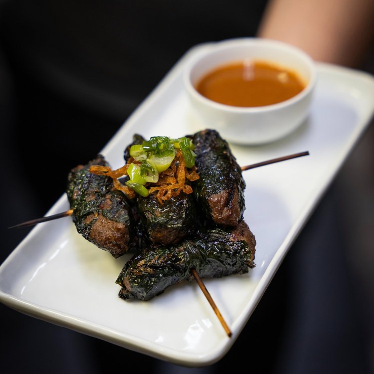 Betel leaf wrapped beef skewers