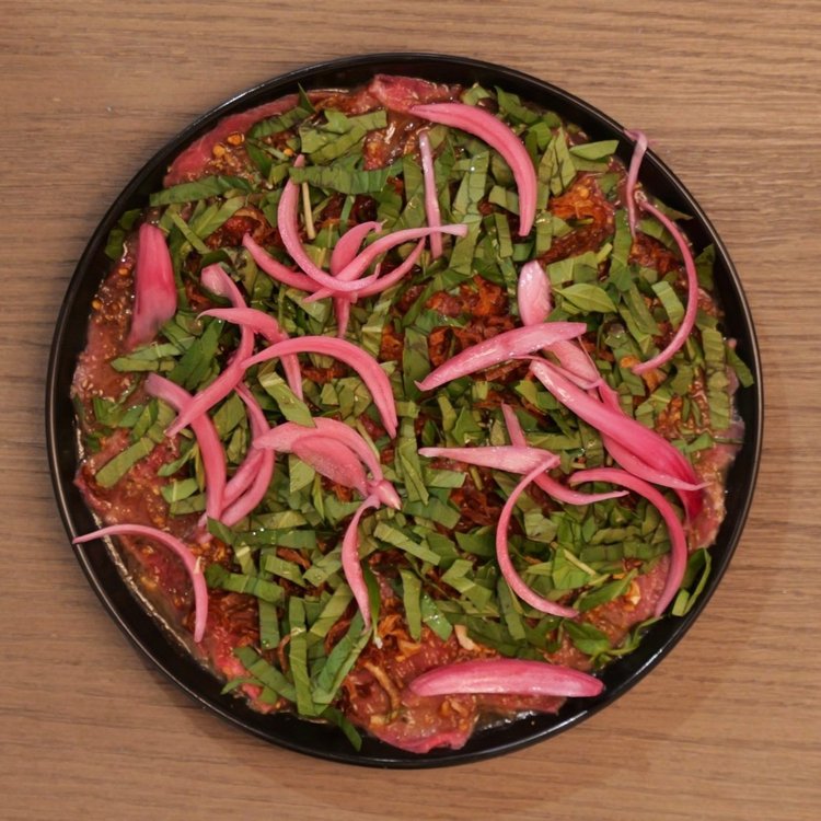 Butter beef carpaccio with basil and pickled onions