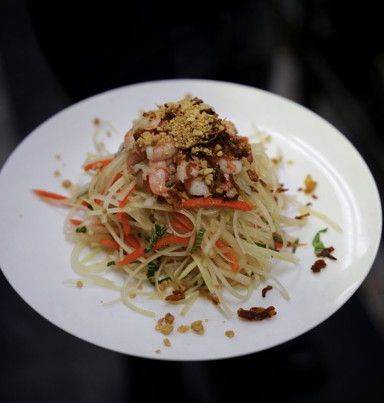 Green papaya salad topped with shrimp