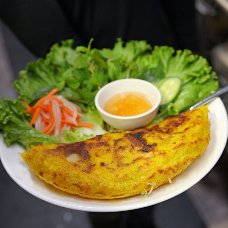 Sizzling Saigon crepe banh xeo with herbs