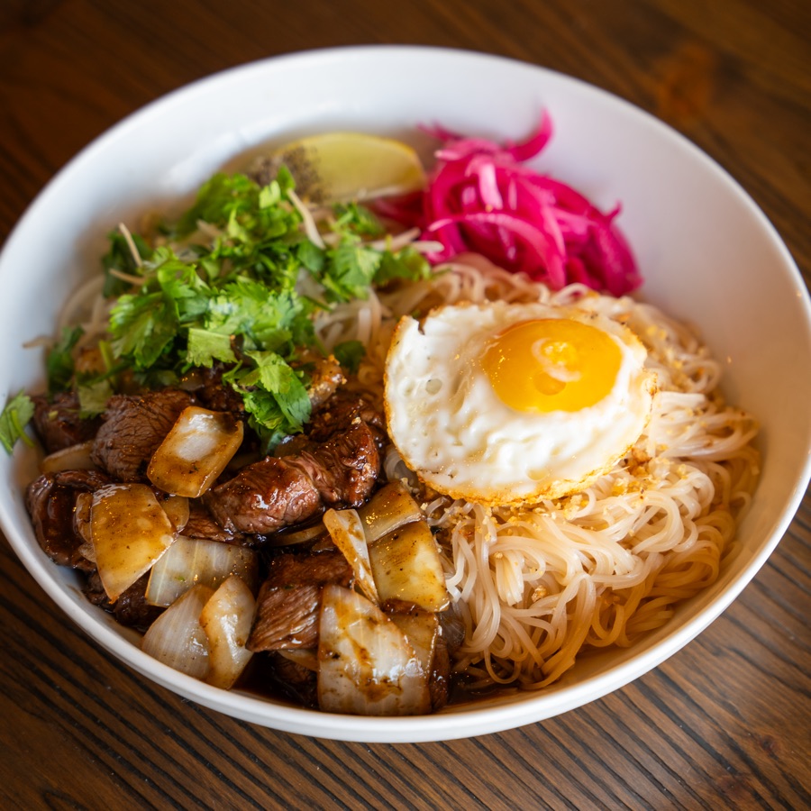 Mámì's shaken noodles — pho noodles with wok-tossed beef tenderloin, fried egg and pickled onions